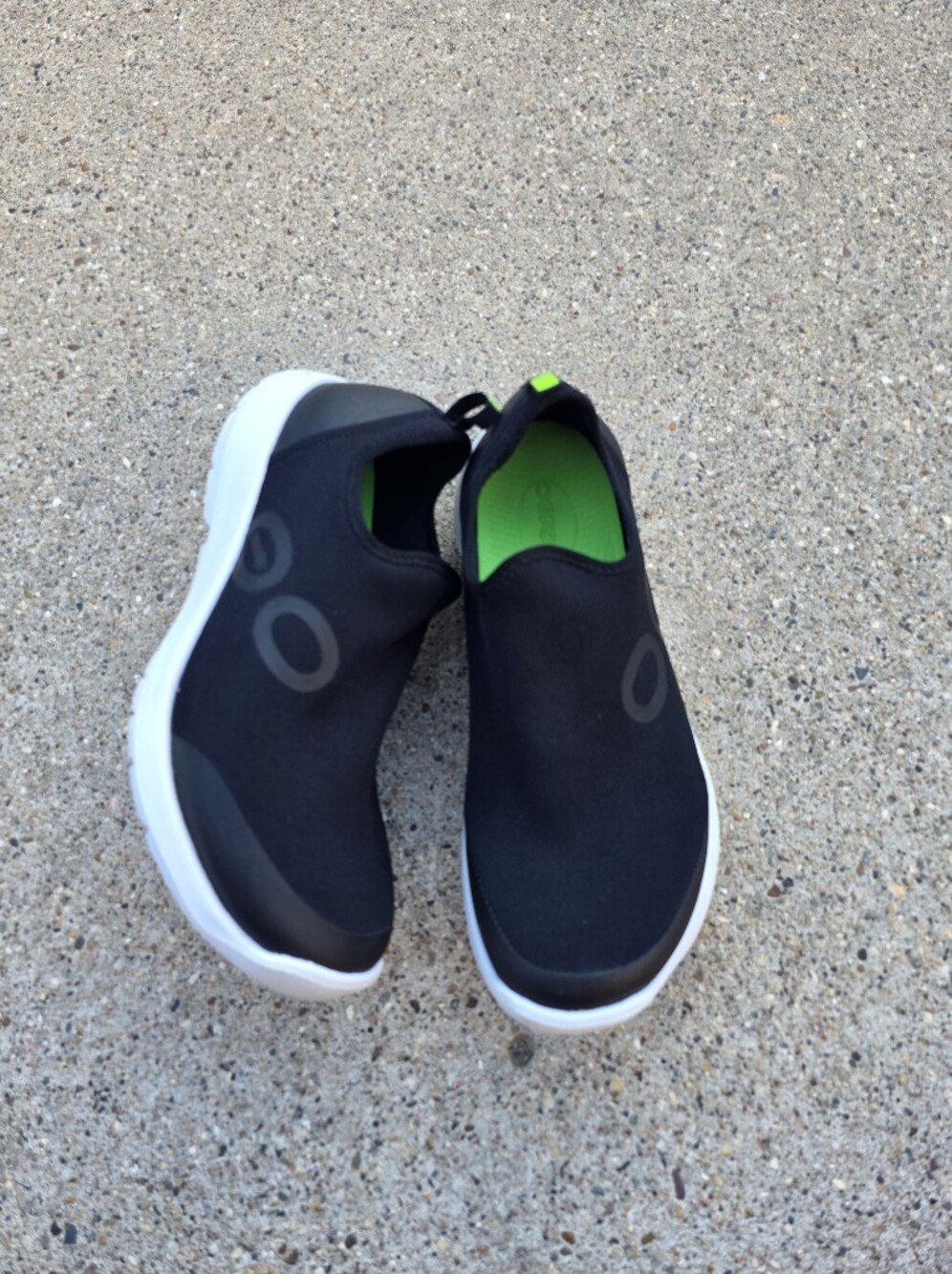 Oofos Slip-On Sneakers in Black with Green Accent